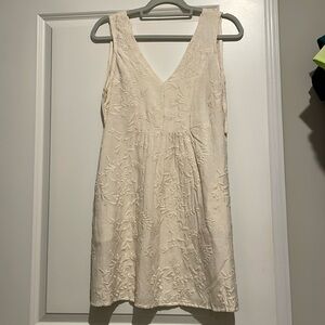 Cream dress with tie in the back.